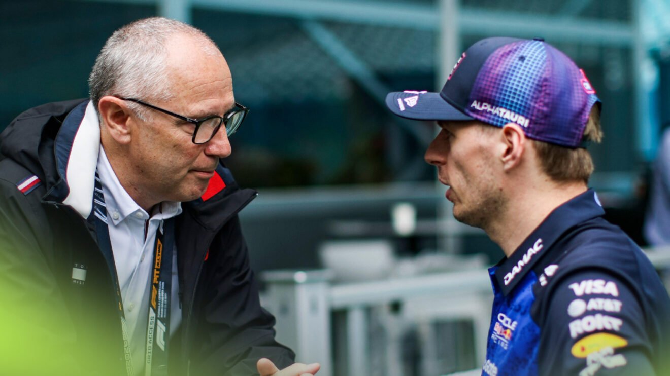 Stefano Domenicali in conversation in the F1 paddock amid talks over Max Verstappen's future and 2027 regulations.