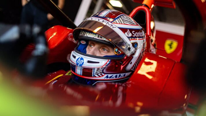 Maya Weug sets in the cockpit of a Ferrari-branded F1 Academy car with the visor of her helmet open