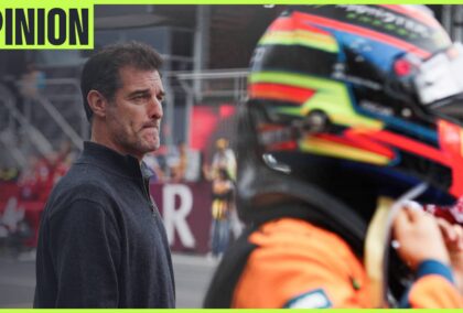 Oscar Piastri fastens his helmet on the grid as Mark Webber looks on in the background. An 'opinion' tab is in the top-left corner