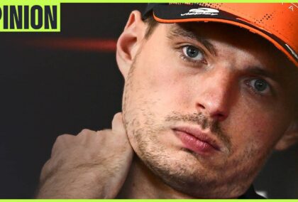 Max Verstappen tilts his head in a press conference while holding his hand to his neck. An 'opinion' tab is in the top-left corner