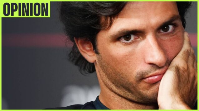 A close-up shot of Carlos Sainz holding his hand to his face with an 'opinion' tab in the top-left corner