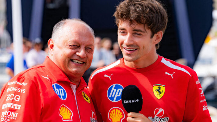 Charles Leclerc and Fred Vasseur laughing while being interviewed, Leclerc holding the mic