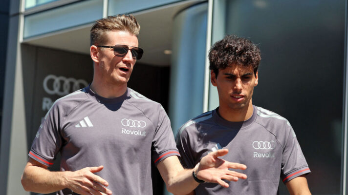 Nico Hulkenberg gesturing as he speaks with Gabriel Bortoleto