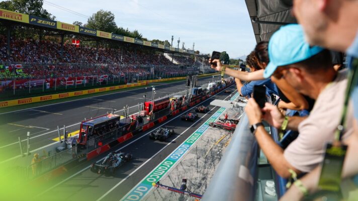 Fans watch on as cars head down the pit lane at the Italian Grand Prix in Monza.