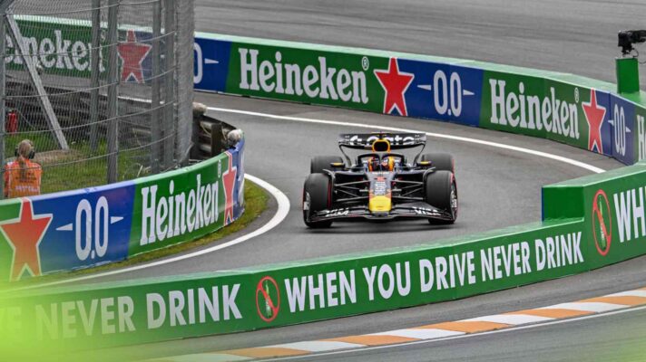 F1 live action as Max Verstappen leaves the pit lane.