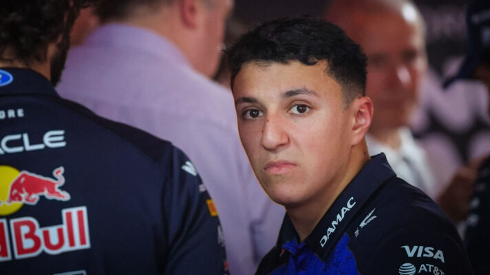 Isack Hadjar staring ahead in the Red Bull garage