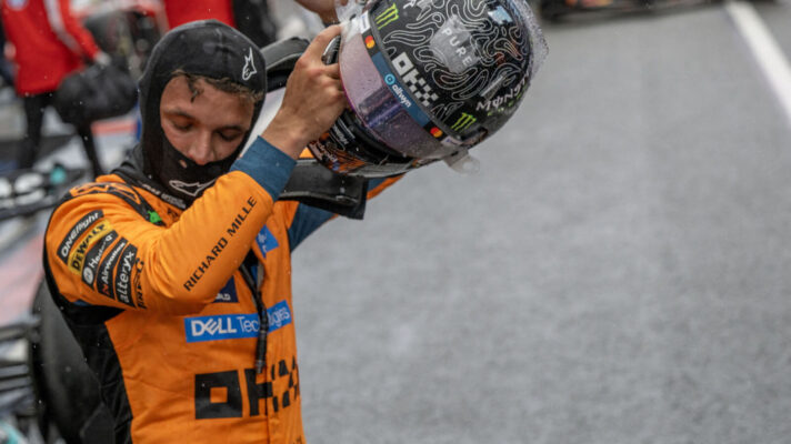 Lando Norris removes his helmet