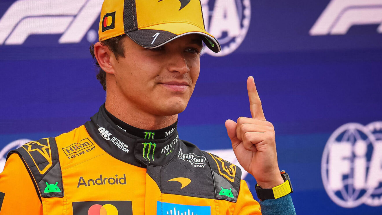 Lando Norris raises his finger in celebration