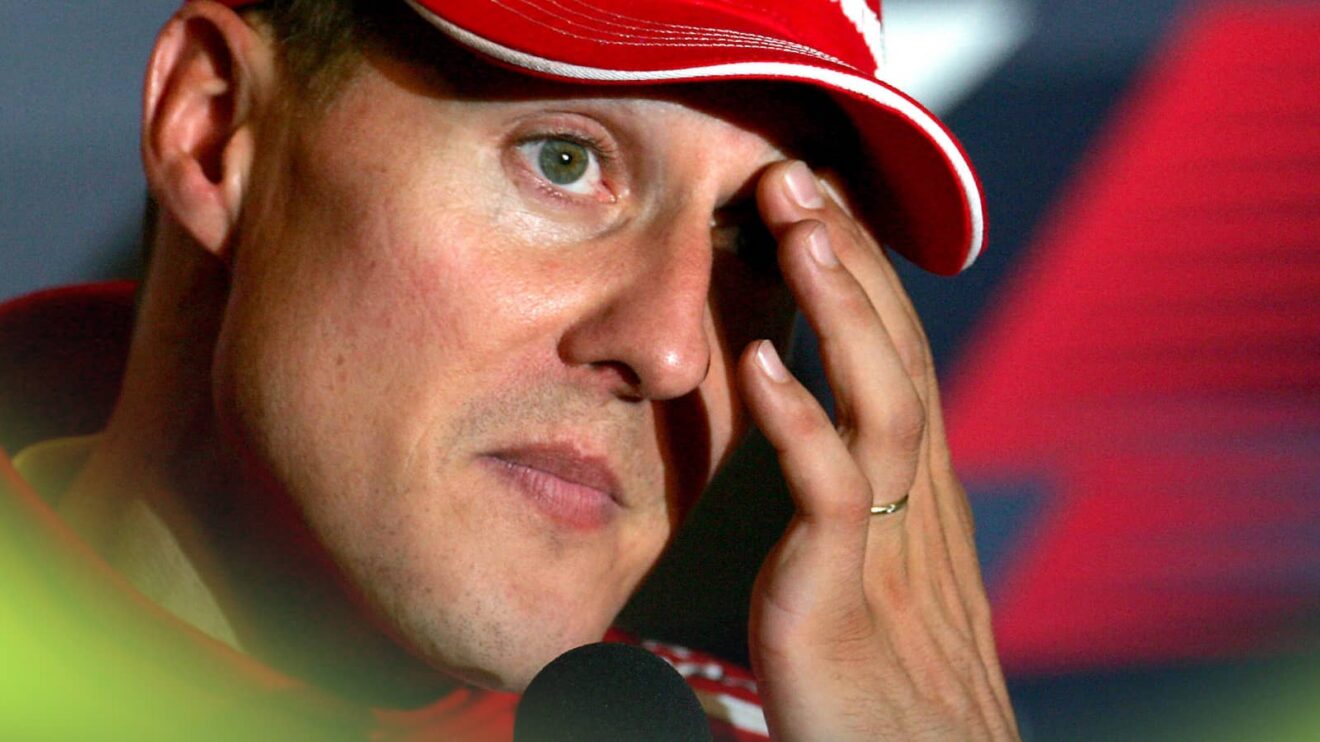 Michael Schumacher wiping his eye in a press conference