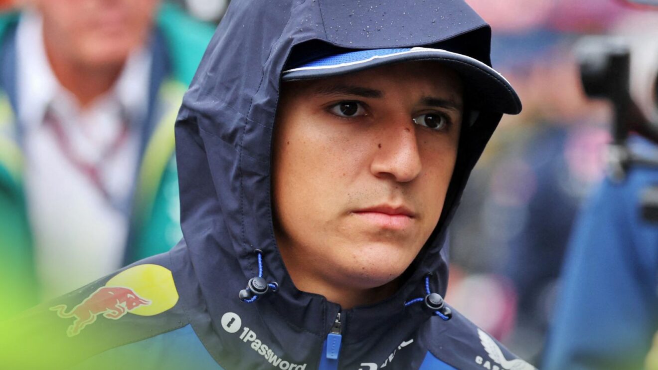 Isack Hadjar walks with his hood up.