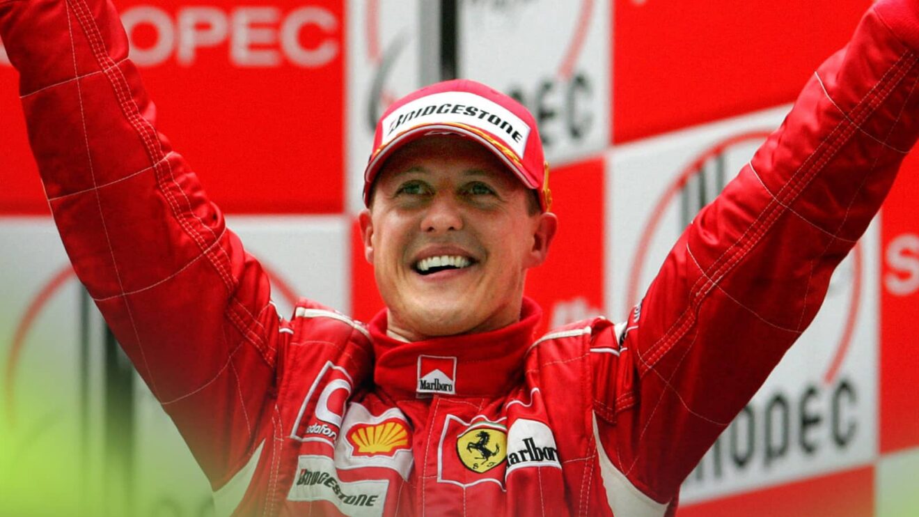 Michael Schumacher smiles and holds his hands outstretched on the podium at China 2006