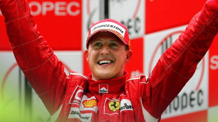 Michael Schumacher smiles and holds his hands outstretched on the podium at China 2006