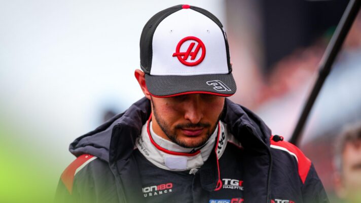 Esteban Ocon with his head down.