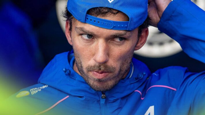 Pierre Gasly wearing blue Alpine team kit as he leaves the FIA garage
