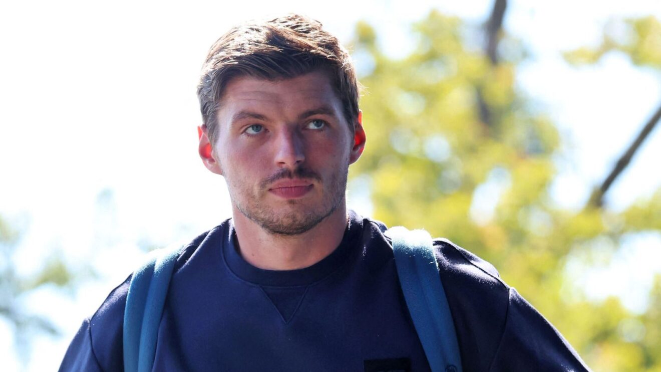 Max Verstappen walks into the paddock on media day.