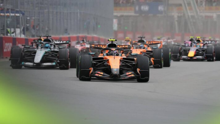 Lando Norris leads a pack of cars at the start in Canada