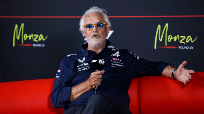Flavio Briatore gesturing while sitting on the press conference couch in Monza