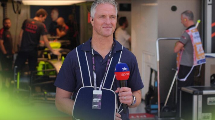 Ralf Schumacher, pictured with his right arm in a sling and holding a Sky microphone, at the 2026 Italian Grand Prix