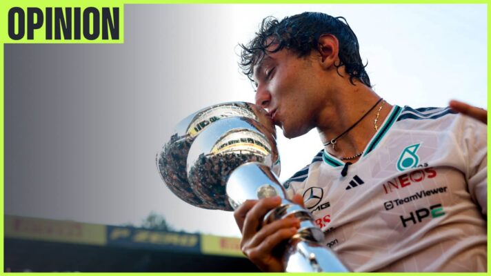 Kimi Antonelli kisses the winners' trophy at Zandvoort with the sky above him and an 'opinion' tab in the top-left corner