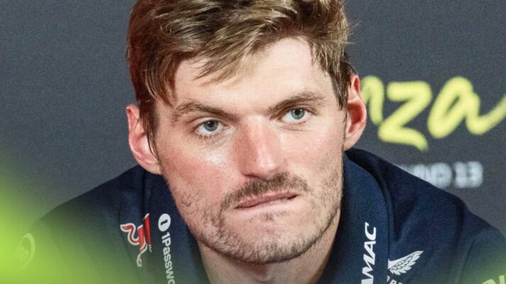 A close-up shot of Max Verstappen biting his bottom lip in a press conference