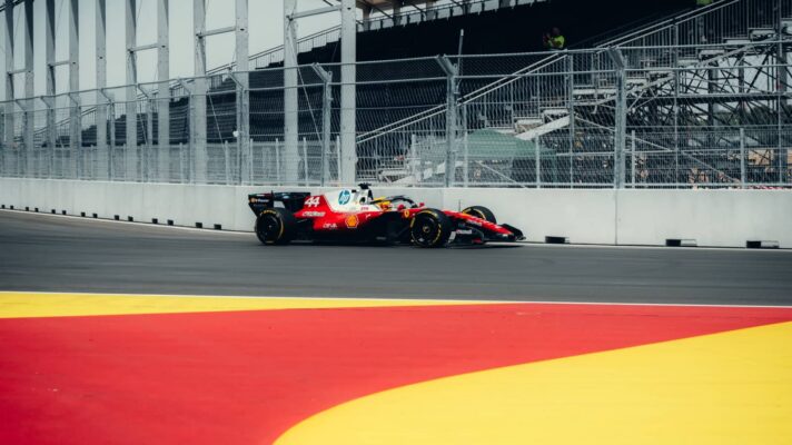 Lewis Hamilton's Ferrari on track at a deserted Madring with a run-off area painted in the colours of the Spanish flag in the foreground