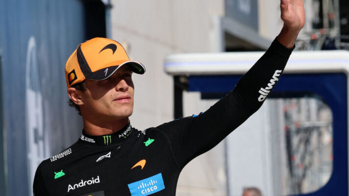 Lando Norris waves at the crowd