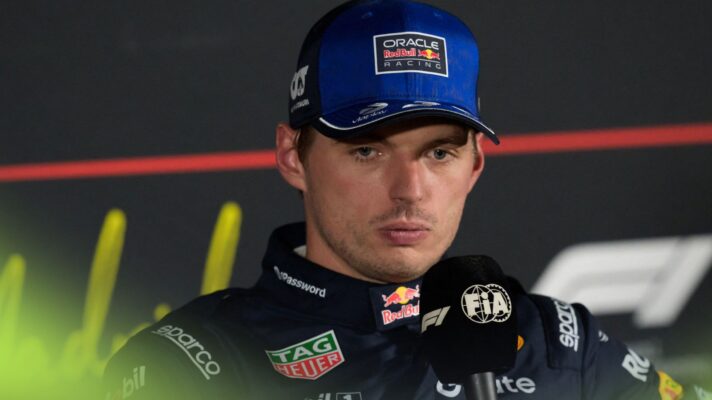 Max Verstappen looks down in a press conference.