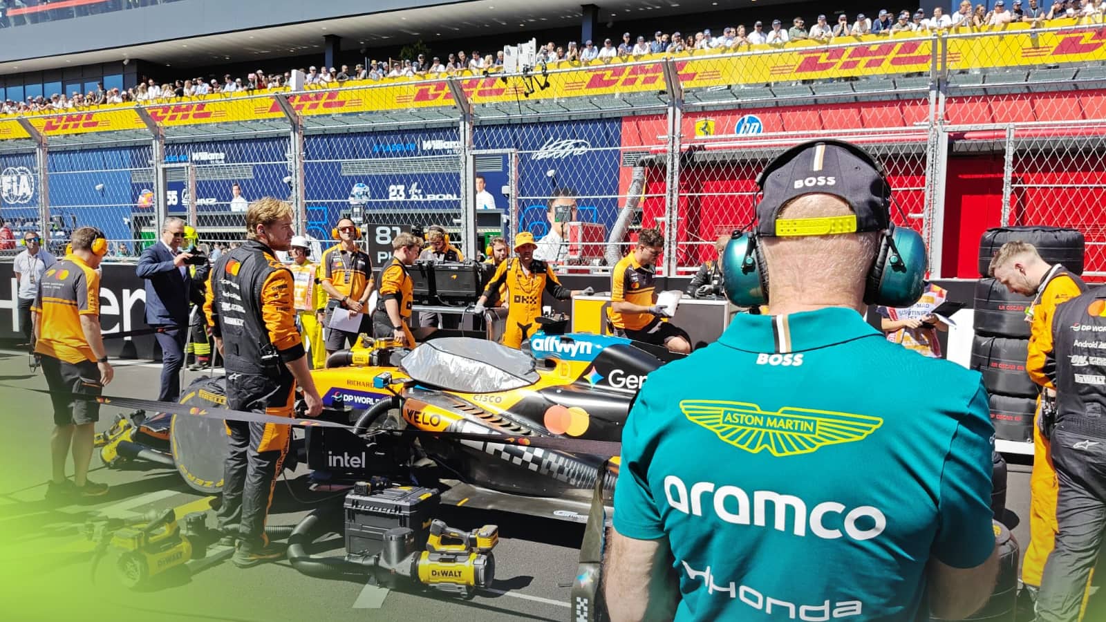 An over-the-shoulder shot of Adrian Newey looking at the McLaren MCL40 on the grid in Madrid