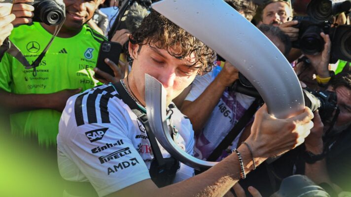 Kimi Antonelli kisses his P1 trophy after winning the 2026 Spanish Grand Prix