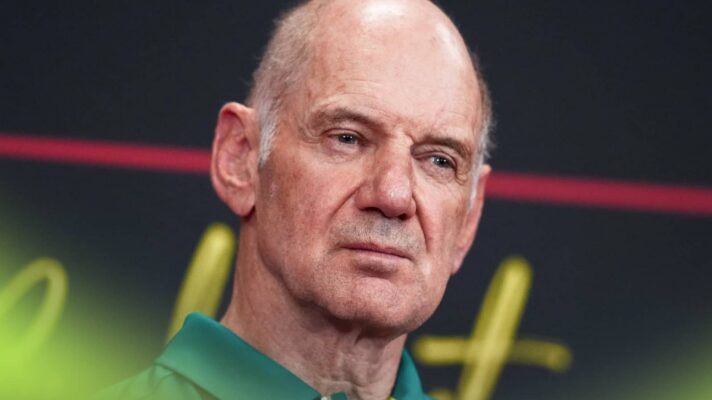 Adrian Newey narrows his eyes as he looks on in a press conference