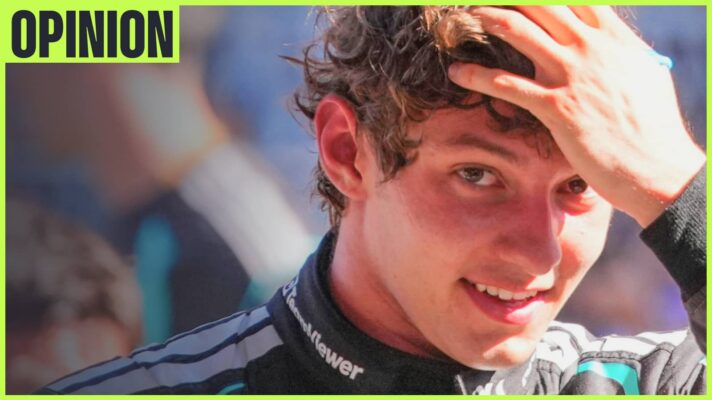 Kimi Antonelli smiles as he eyes the camera while running a hand through his hair. An 'opinion' tab is in the top-left corner
