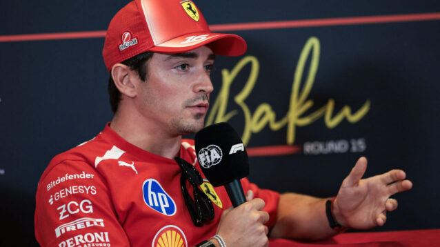 Charles Leclerc gestures as he speaks with the media in a press conference