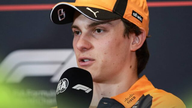 Oscar Piastri speaks into a microphone during a press conference