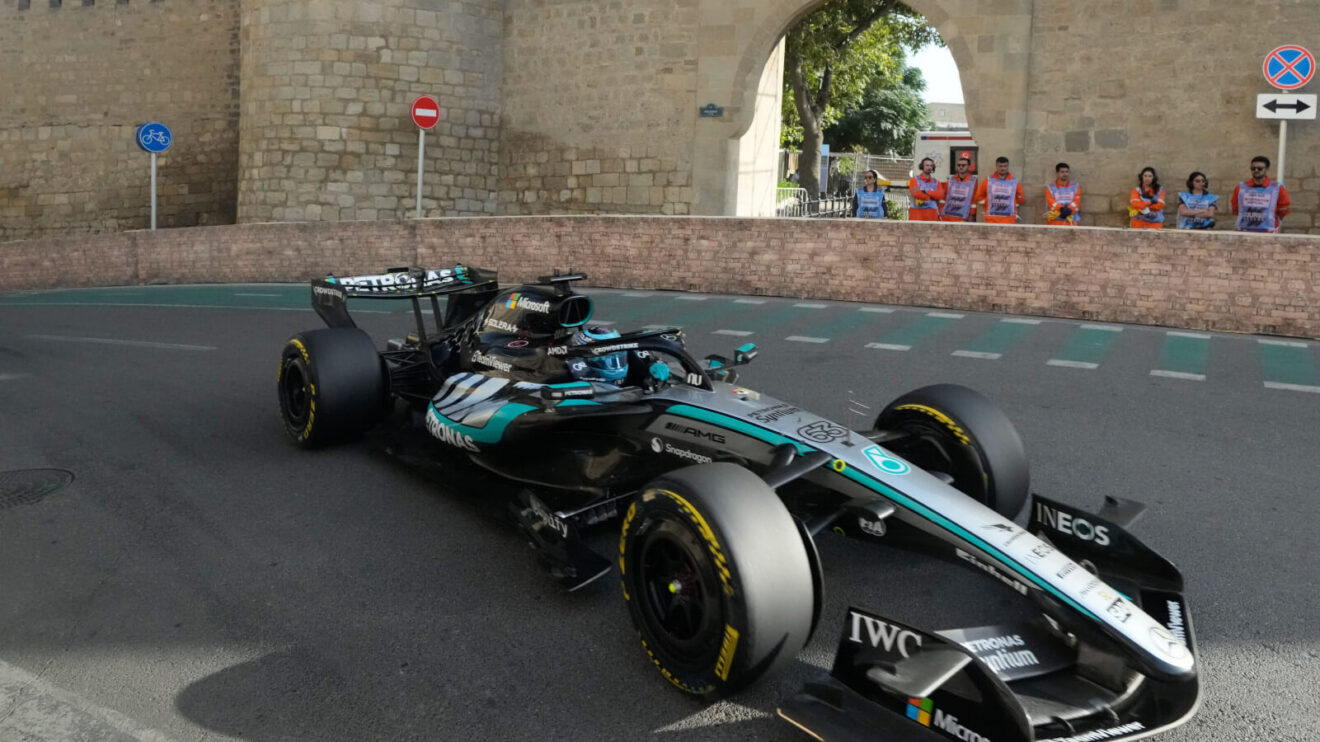 George Russell watched by the marshals as he laps the Baku circuit