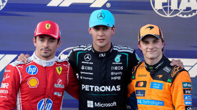 George Russell poses after qualifying with Charles Leclerc and Oscar Piastri