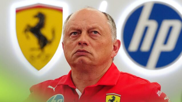 Fred Vasseur looks on in the Ferrari garage with the prancing horse and HP logos in the background