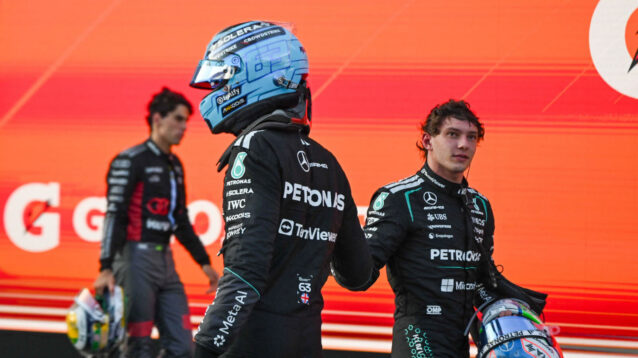 George Russell and Kimi Antonelli shake hands as they walk past each other
