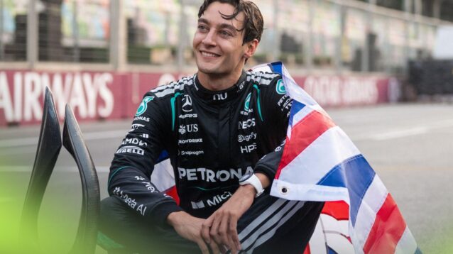 George Russell, Mercedes, poses with the British flag and P1 trophy after winning the 2026 Azerbaijan Grand Prix