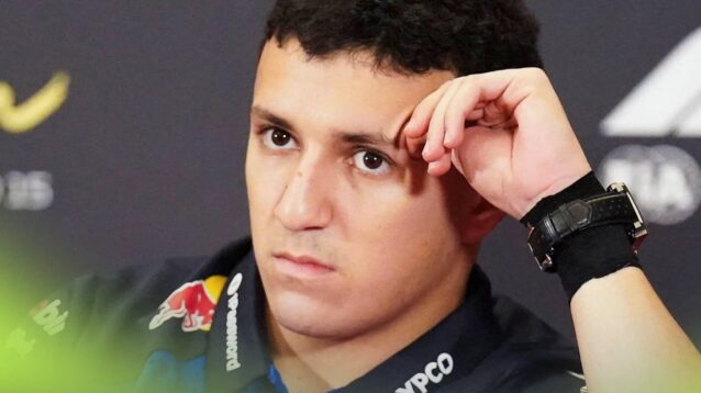 Isack Hadjar rests his head on his hand in a press conference