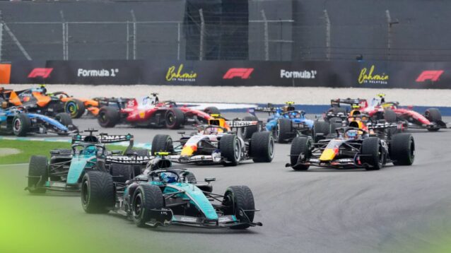 The F1 field navigates Turns 1 and 2 at the start in Sepang