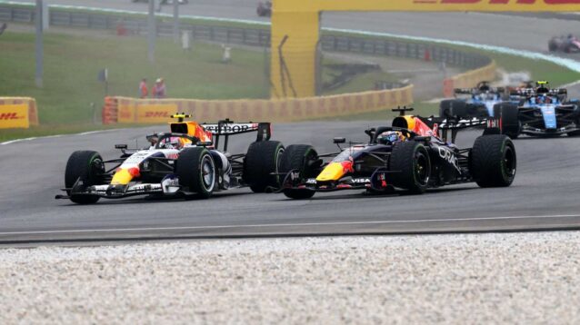 Liam Lawson and Max Verstappen race wheel to wheel at Sepang.
