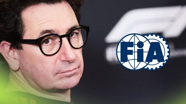 Mattia Binotto looks on in a press conference with a prominent FIA logo alongside him