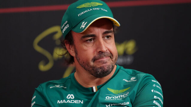 Fernando Alonso looking on in a press conference
