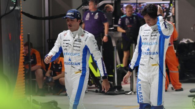 Sainz and Albon trudge down the pit lane in Singapore