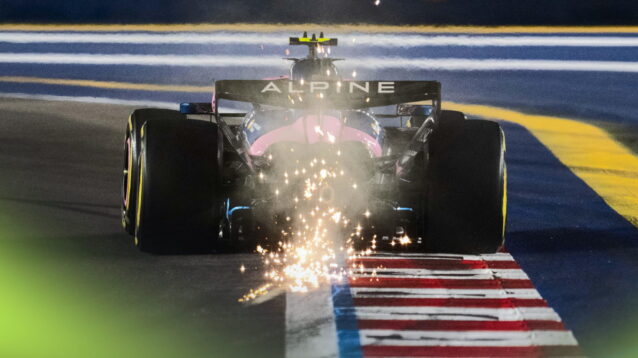A rear-facing shot of Franco Colapinto's Alpine kicking up a shower of sparks at night in Singapore
