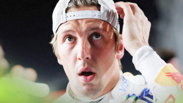 Liam Lawson holds a hand to his head with his mouth open on the grid in Singapore