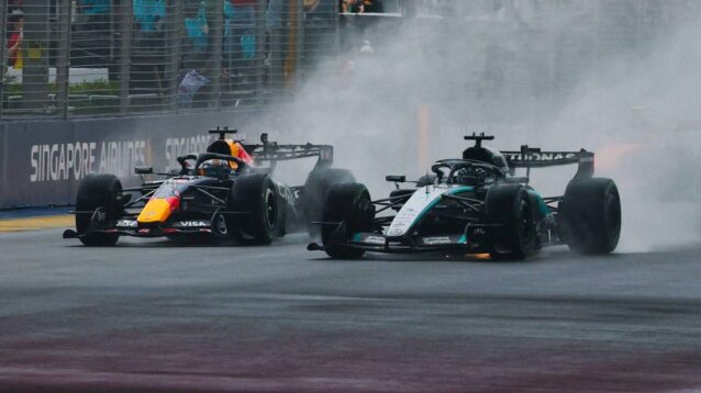 Red Bull driver Max Verstappen alongside George Russell at the start of the Singapore GP Sprint.