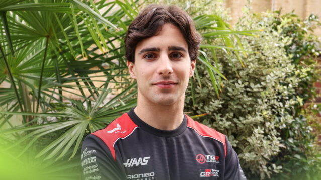 Rafael Camara wearing a Haas t-shirt with green bushes in the background