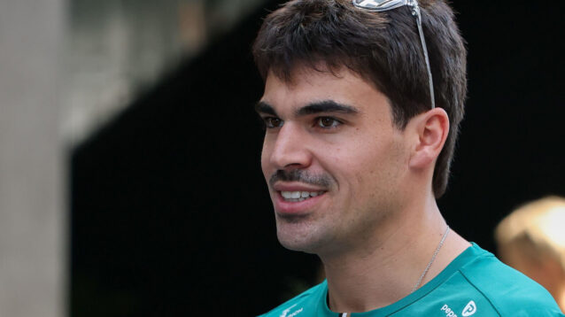 Lance Stroll smiling, sunglasses on top of his head