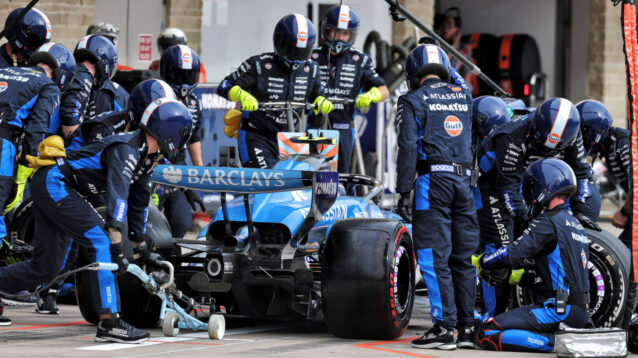 Carlos Sainz in the pits, surrounded by Williams mechanics for a pit stop